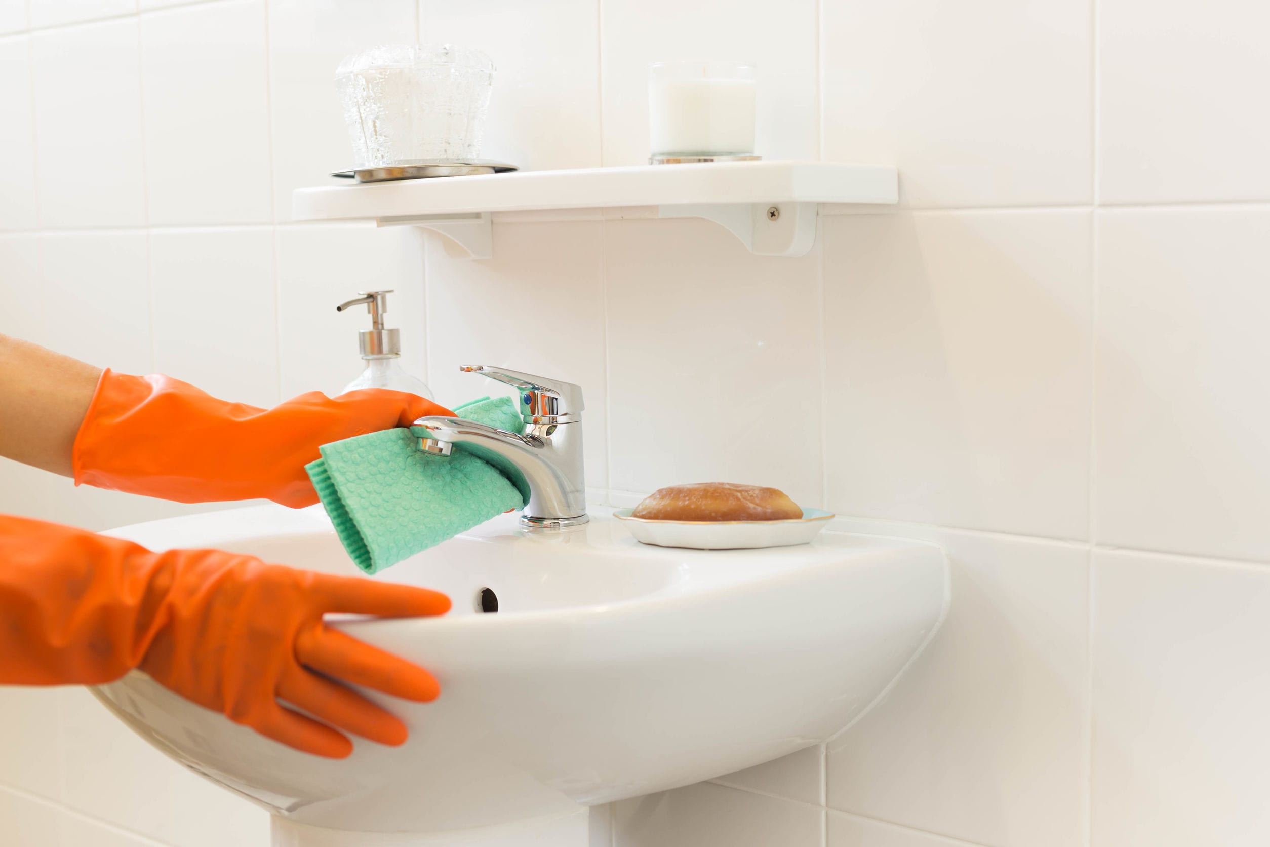 Woman cleaning water tap